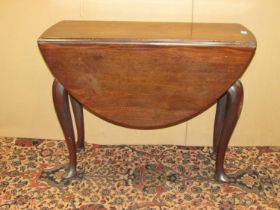 A small George III mahogany drop leaf table with frieze drawer, raised on four shaped supports