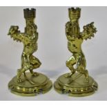 A good pair of heavy 19th century brass heraldic candlesticks, a symmetrical pair of Heraldic lions,