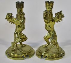 A good pair of heavy 19th century brass heraldic candlesticks, a symmetrical pair of Heraldic lions,