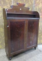 A narrow Regency mahogany side cupboard with raised back over a pair of rectangular panelled doors