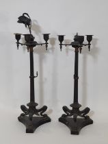 A pair of 19th century continental bronze three light candelabra, with crane and turtle finials in