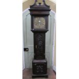 A Georgian oak longcase clock the case with later carved detail, enclosing a square brass dial