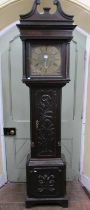 A Georgian oak longcase clock the case with later carved detail, enclosing a square brass dial