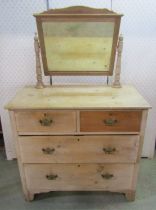 A small striped pine dressing chest of two long and two short drawers, with raised mirror back