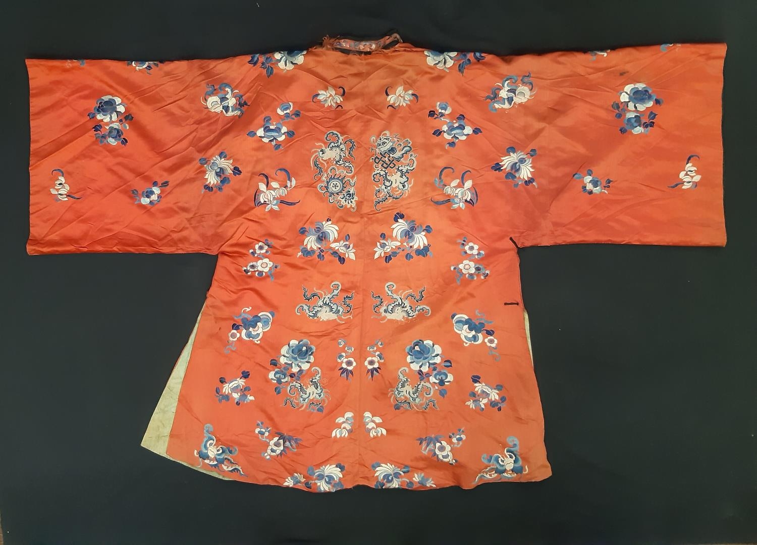 A late 19th/ early 20th century Chinese robe of red silk embroidered with flowers, moths and other - Image 2 of 8