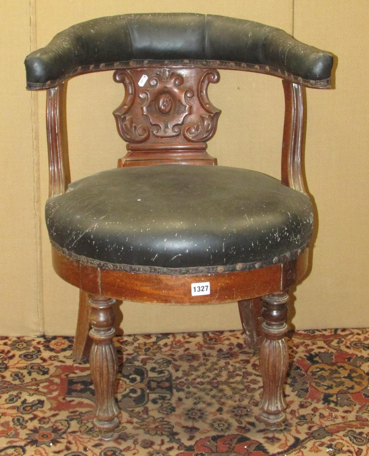 A 19th century mahogany library chair with carved splat, horseshoe shaped back and circular seat