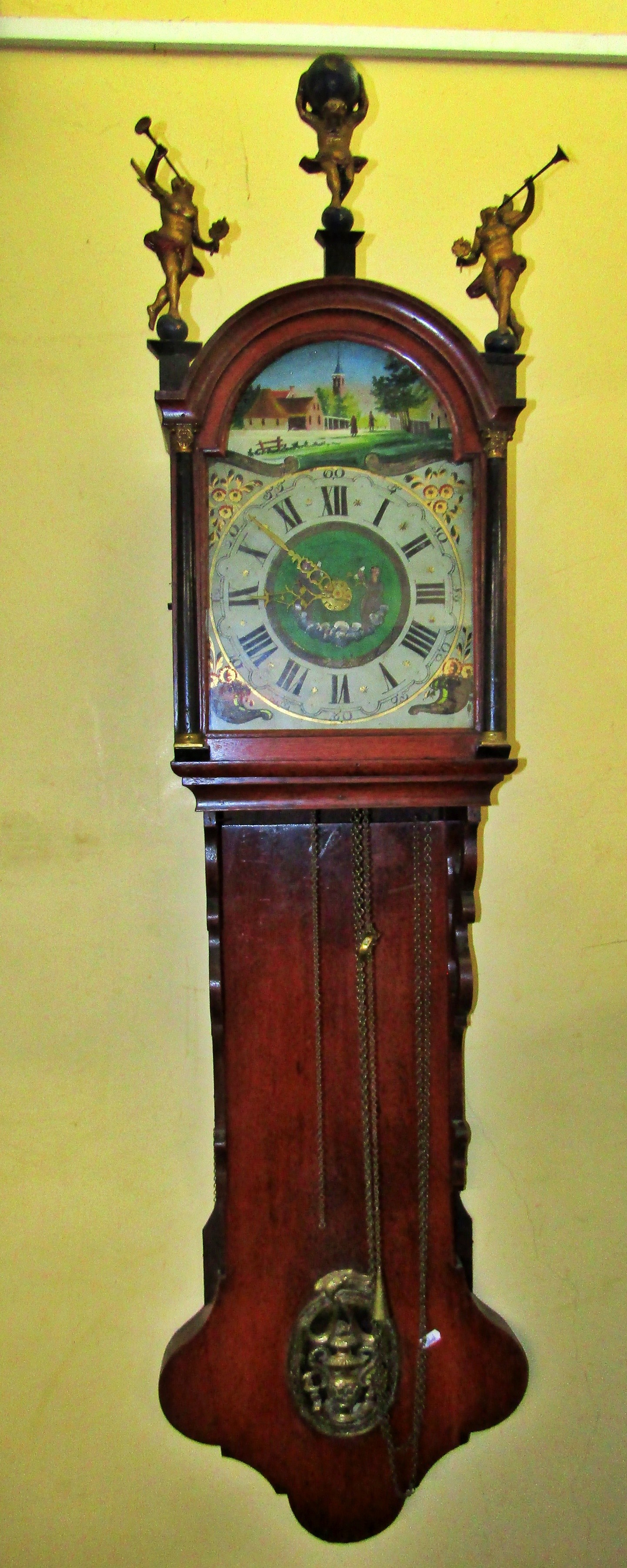 A 19th century Dutch wall clock with painted arched dial, surmounted with a painted rural landscape,