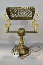 An early 20th century American brass desk lamp with pierced adjustable shade held by S supports