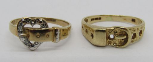 Two vintage 9ct buckle design rings to include a heart shaped diamond set example (one diamond