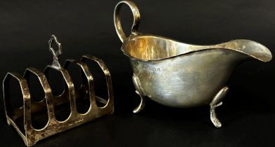 A mixed selection of 19th century silver including a gravy boat, snuff box, vesta, toast rack, and a