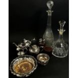 A mixed selection of silver plated table wares, including a wine coaster, teapots, cake slice,