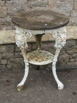 A Victorian cast iron pub table, circular with female mask detail, with weathered oak top, 51cm