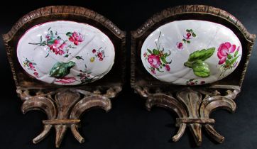 A pair of 19th century French carved wood brackets with fleur-de-lis, each incorporating floral
