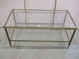 A Regency style brass framed two tier occasional table with glass panel, 90cm x 46cm x 41cm high