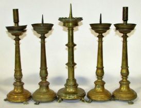 A group of five various ecclesiastical brass candlesticks, mostly 19th century, to include a good