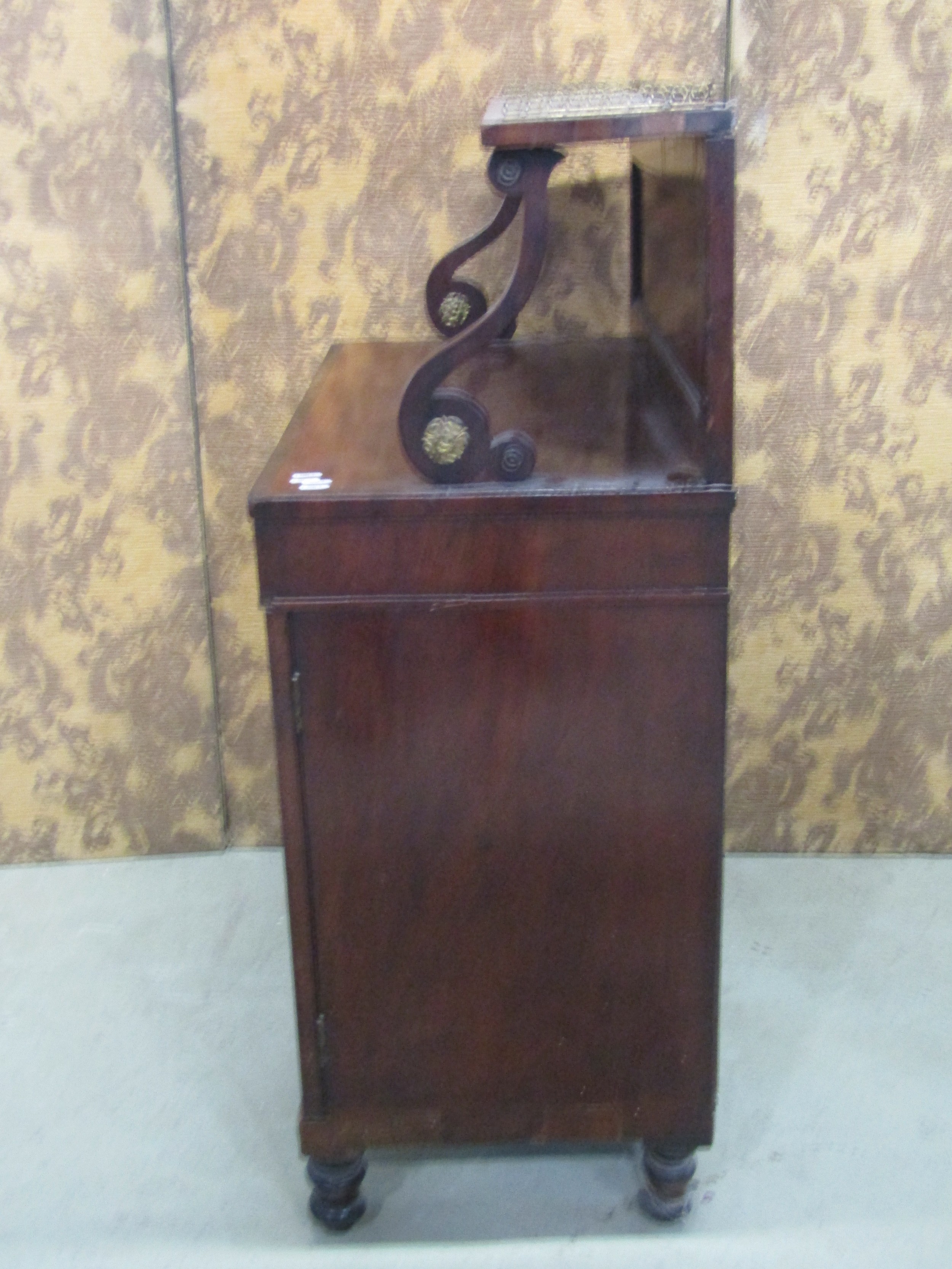 A Regency mahogany Chiffonier enclosed by two brass grilled doors beneath a raised and shaped back - Image 2 of 3