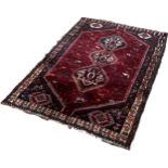 A Middle Eastern Carpet with interlocking lozenge medallions with field of stylised animals and
