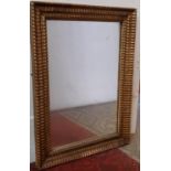 A 19th century wall mirror with repeating geometric frame and original gilded finish, 72cm x 53cm