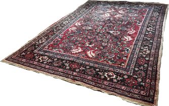 A Persian Hamadan type carpet with an all over floral pattern on a predominantly red ground, 290 x