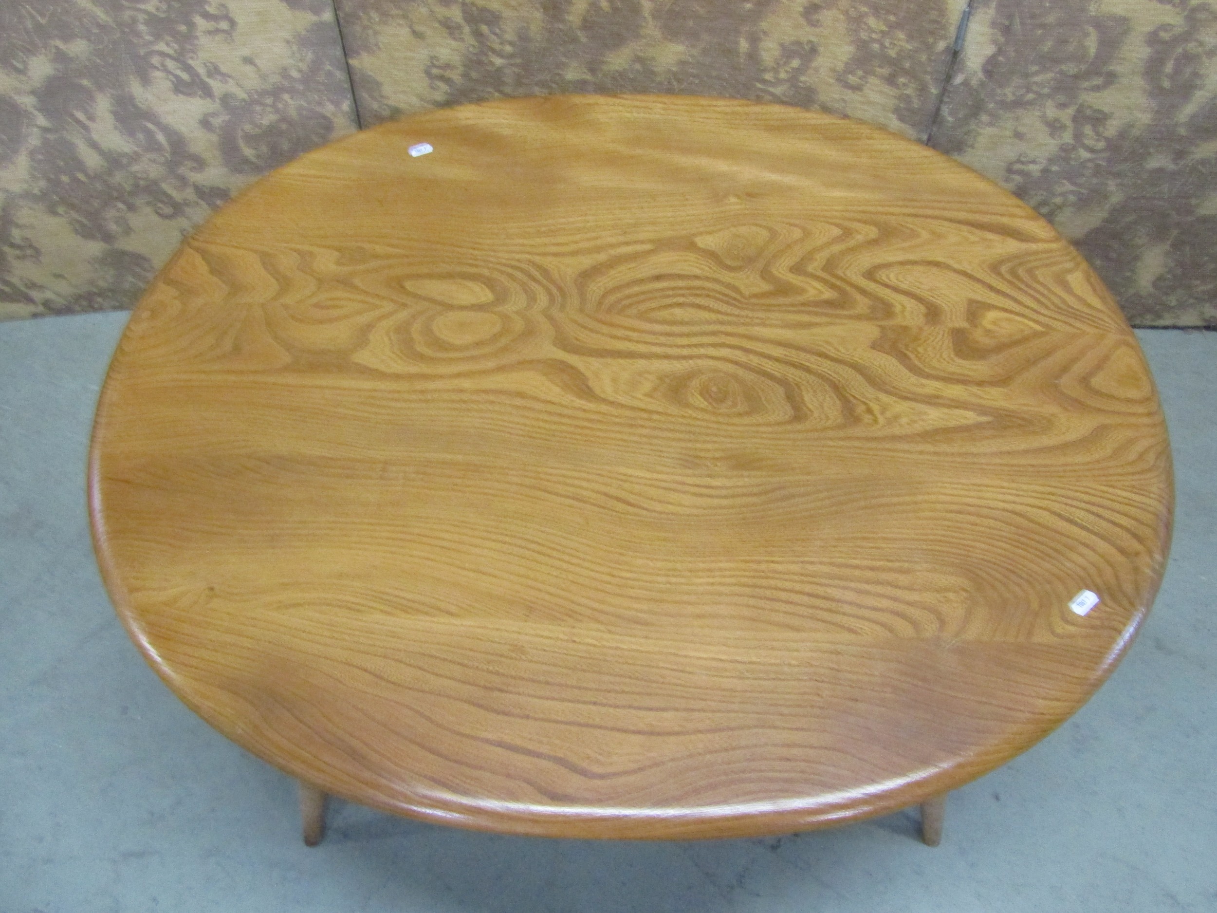 An Ercol occasional table of oval form, on turned supports with under gallery, with well figured elm - Image 2 of 2