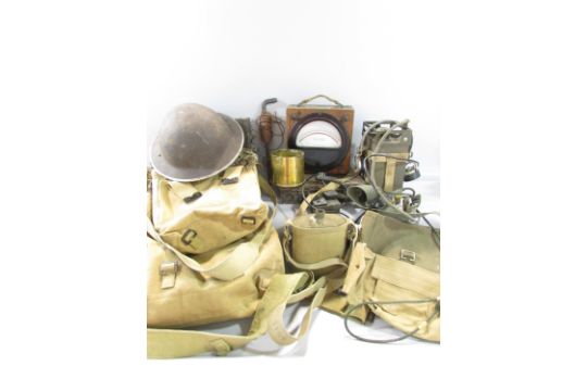 A collection of WWII Equipment, including a ruck sack, webbing, helmet, water bottles, a field - Image 1 of 5