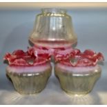 Twelve pink tinged glass light shades 18cm diameter and one other opaque glass shade