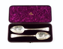 Pair of George III silver Old English Pattern berry spoons, each with an embossed, chased, and