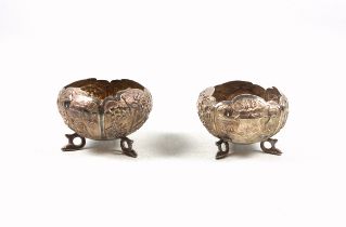 Pair of Anglo-Indian white metal bowls of onion form, each with embossed rural scenes and vacant