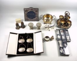 4 silver bottle tickets by D J, Birmingham, 1986, in a Harrods case; napkin ring, gross 60grs; Art