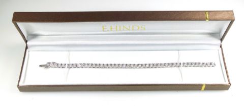 9ct white gold tennis bracelet with 44 illusion set diamonds, L.18.3cm, gross 11.9grs, cased. (2)