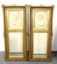 Pair of pier glasses, each with a bevelled plate and young female bust in relief above, in a gilt