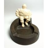 A Michelin bakelite ashtray surmounted by a seated Mr Bibendum, underside moulded stamp 'MADE IN