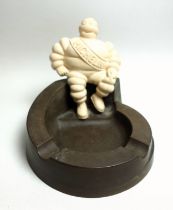 A Michelin bakelite ashtray surmounted by a seated Mr Bibendum, underside moulded stamp 'MADE IN