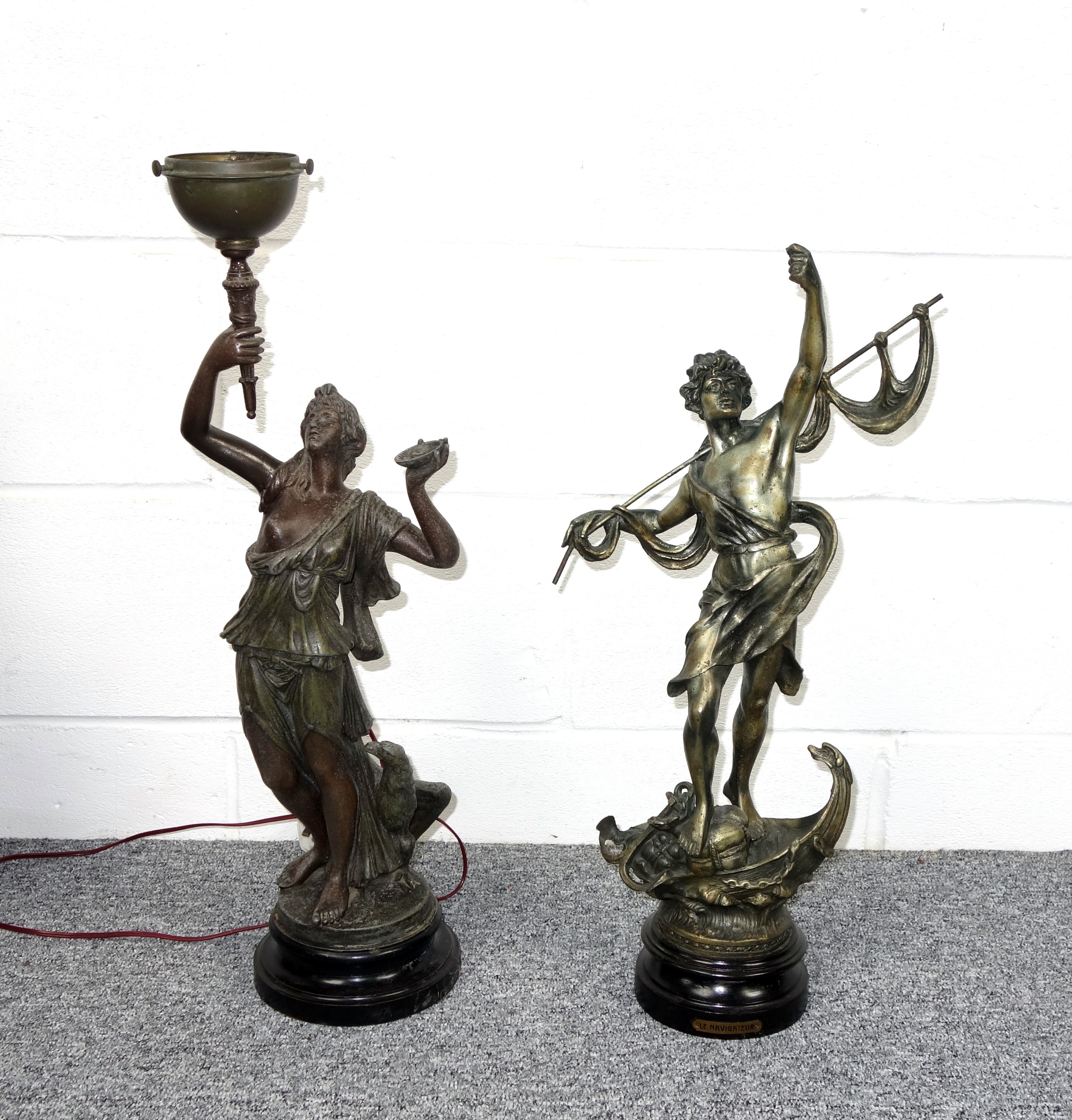 Late 19th Century spelter figure of a semi draped woman holding a torch, an eagle by her feet,