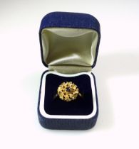 Foreign yellow metal ring with a sapphire in a floral setting, stamped 18k, 5grs, cased. (2)