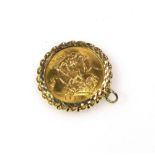 George V gold sovereign, set in a 9ct gold mount, gross 9.3 grams
