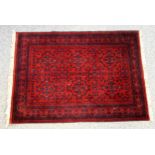 Persian rug, the madder field with 6 anchor medallions and all-over stylised floral decoration,