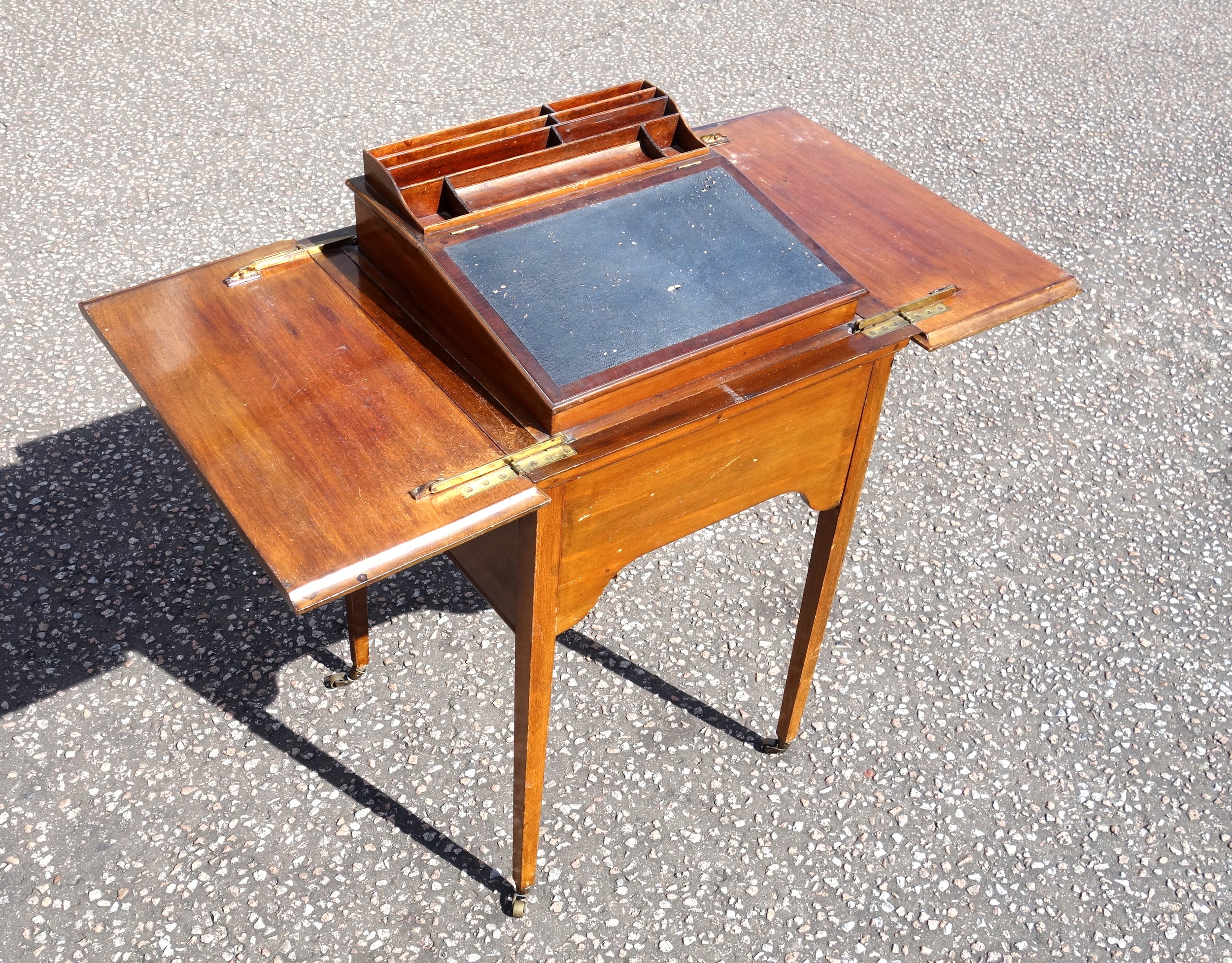 Edwardian Scottish mahogany writing table with a double hinged top raising a slope with pen tray,