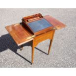 Edwardian Scottish mahogany writing table with a double hinged top raising a slope with pen tray,