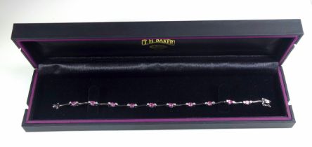 18ct white gold bracelet set with 20 brilliants and pale pink stones, L.18.5cm, gross 7.7grs, cased.