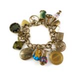 9ct gold charm bracelet with 15 charms, comprising yellow metal Egyptian Pharoah's mask with