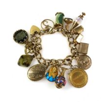 9ct gold charm bracelet with 15 charms, comprising yellow metal Egyptian Pharoah's mask with