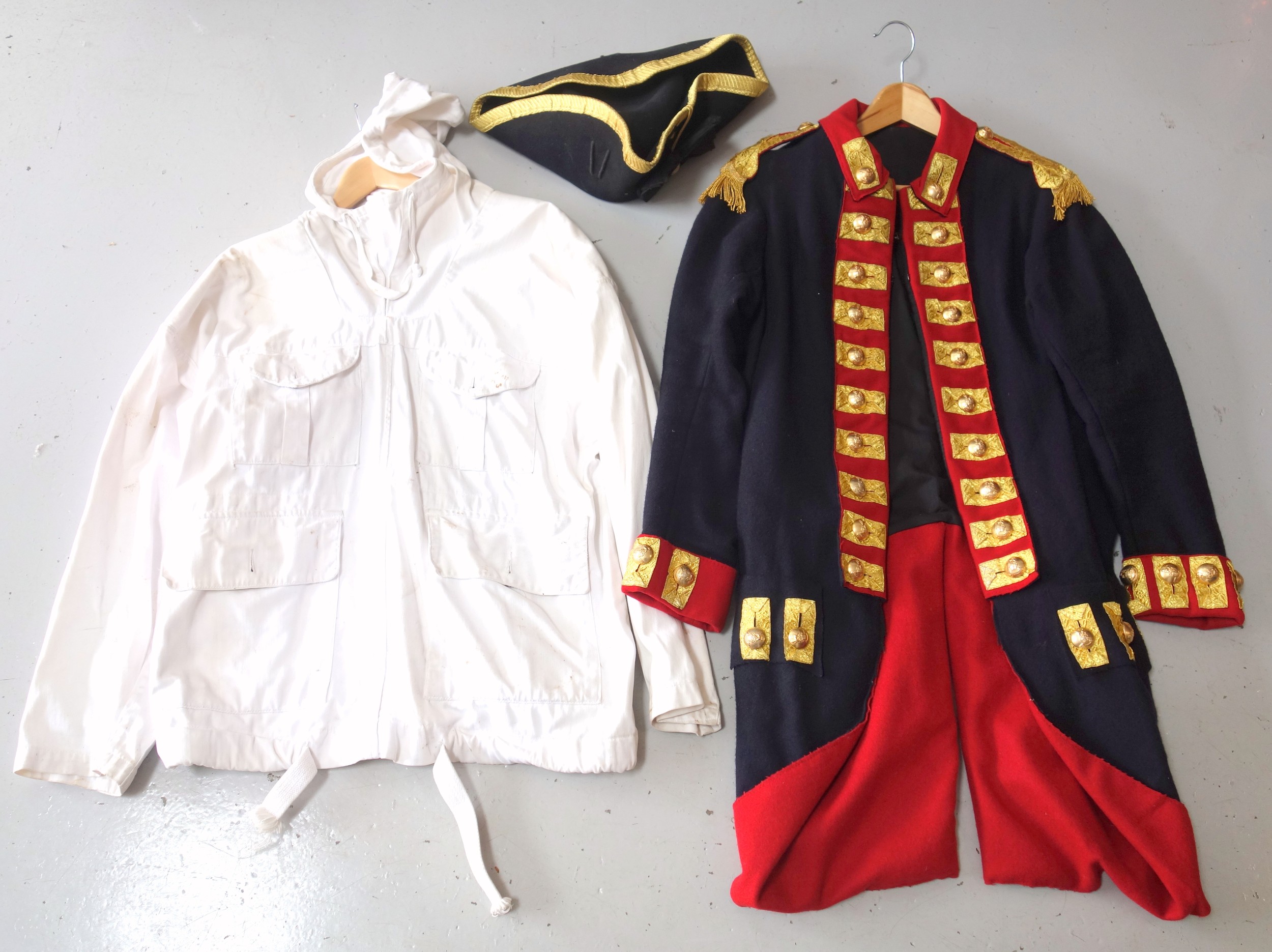 18th century style soldiers tunic, with red and gilt appliques and brass buttons, tricorn hat,