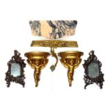 Pair of Italian gilt plaster cherub wall brackets, each with a semi circular top, 29.5 x 23.5cm;