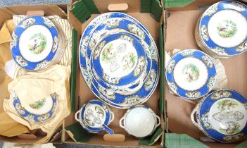 Quantity of Wilton Ware dinner service decorated with bird of paradise and blue border, including
