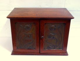 Good Art Nouveau oak smoker's cabinet with 2 floral embossed copper panelled doors enclosing a