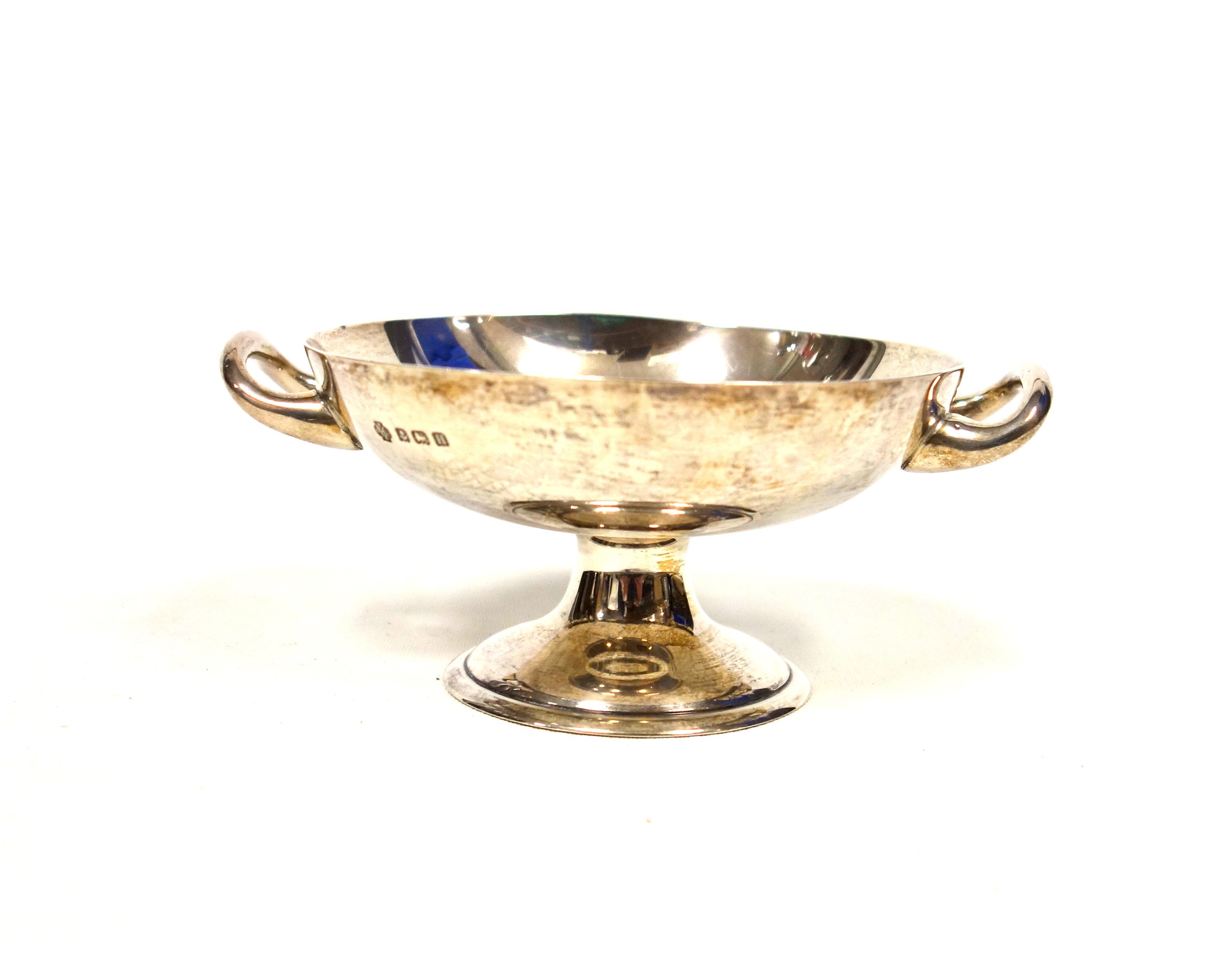 George V silver circular sweetmeat dish with 2 loop handles, on a pedestal foot, by William Hutton &