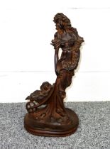 Victorian cast iron group of a maiden wearing flowing costume with flowers and a dog in a barrow