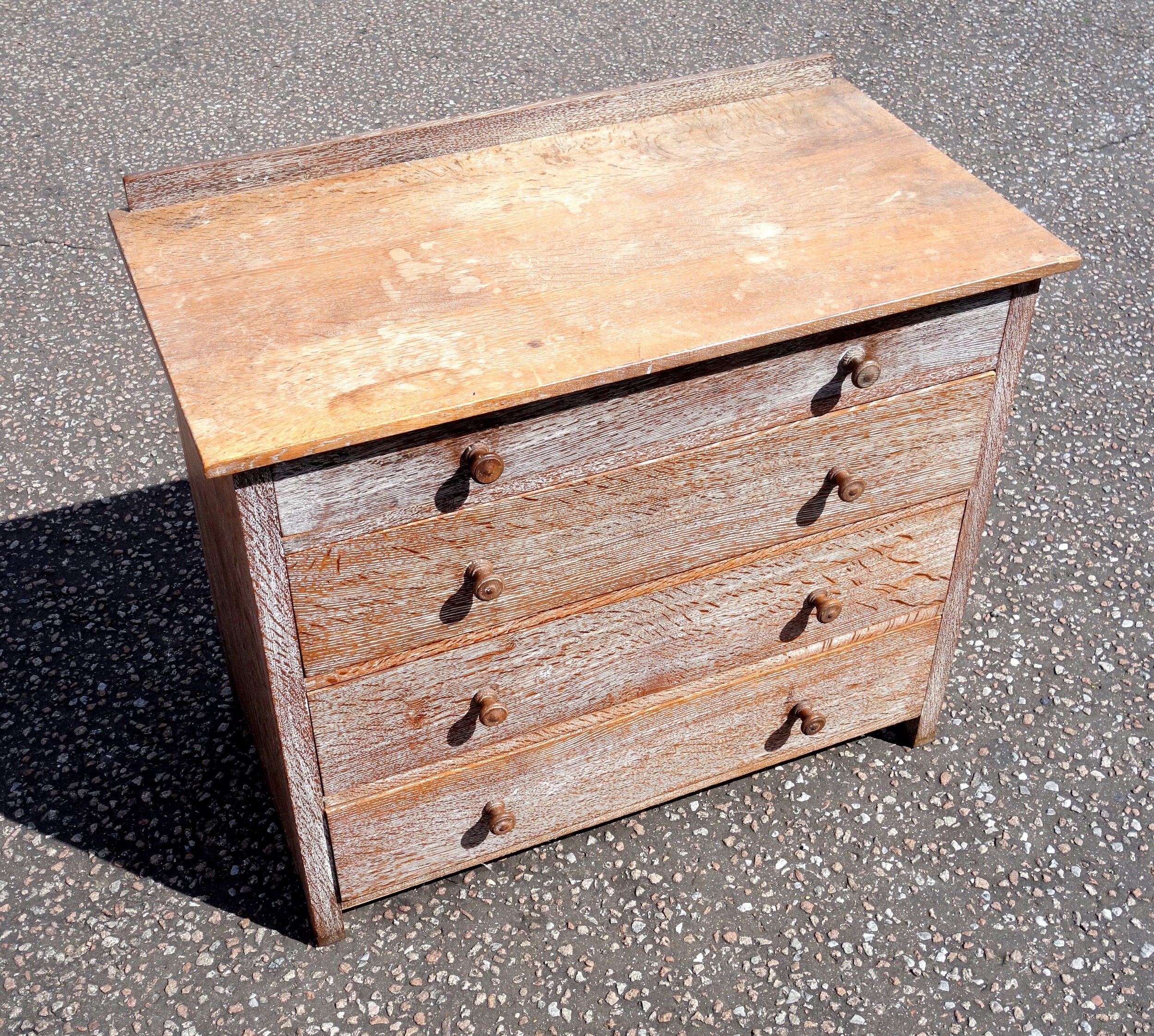 Heal & Son Ltd., London, limed oak chest with 4 graduated long drawers, on square section legs, 75.8