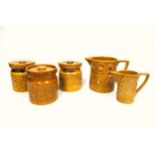 Portmeirion 'Totem' pattern; two matching storage jars with covers, 11cm high, in a mustard coloured